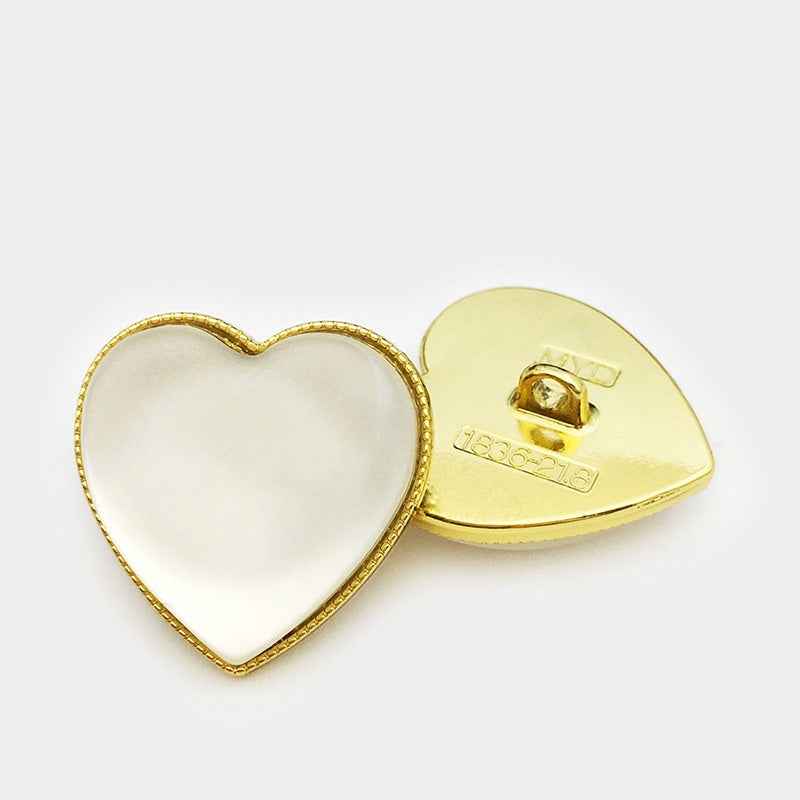 Gold-tone heart decorative button with opal-look center and visible metal back