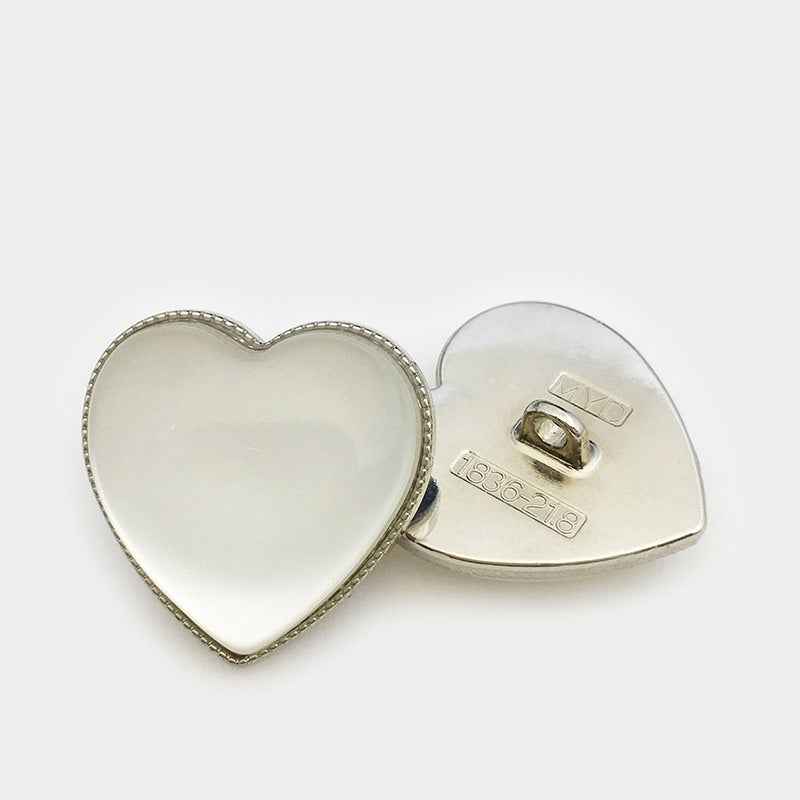 Silver-tone heart decorative button with opal-look center and metal back plate