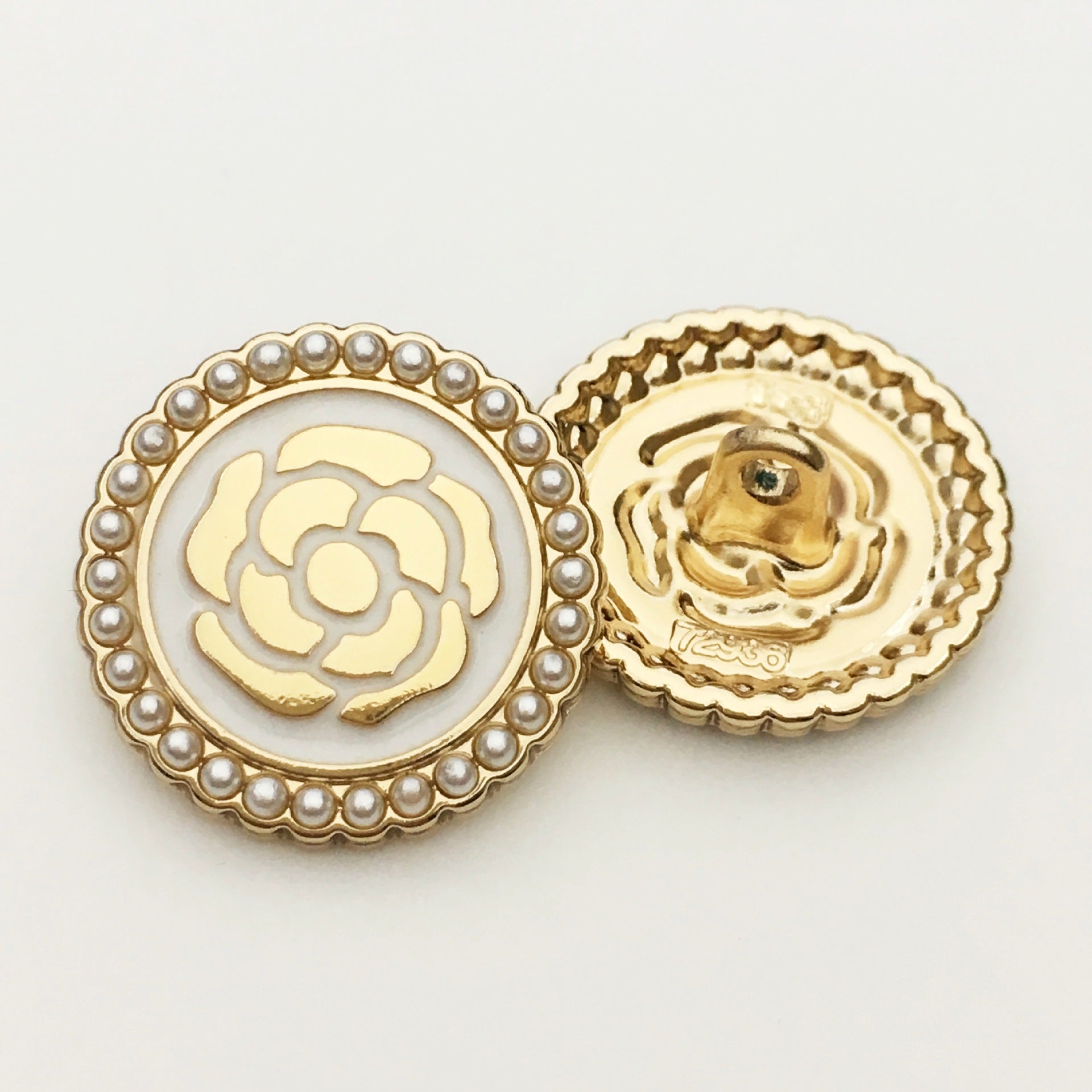 Round metal button with pearl rim and floral rose design, white enamel center, gold back