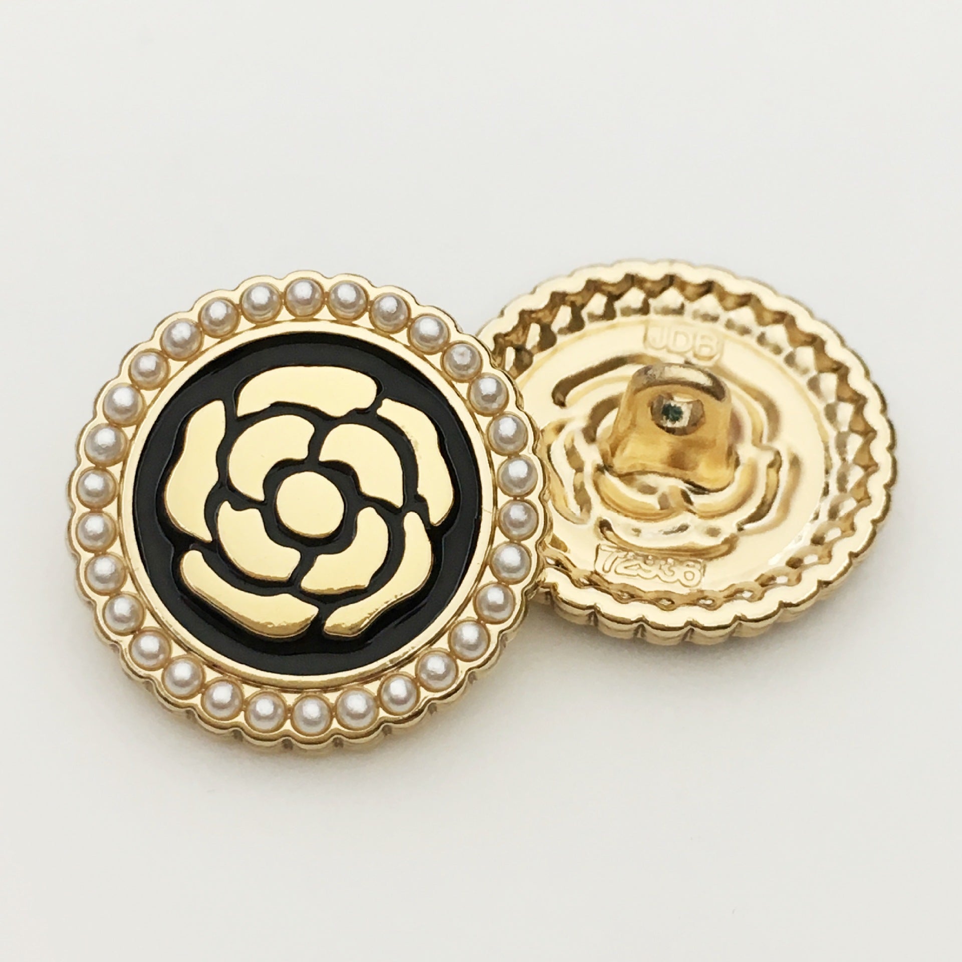 Round metal button with pearl border: black-and-white floral rose front with gold back
