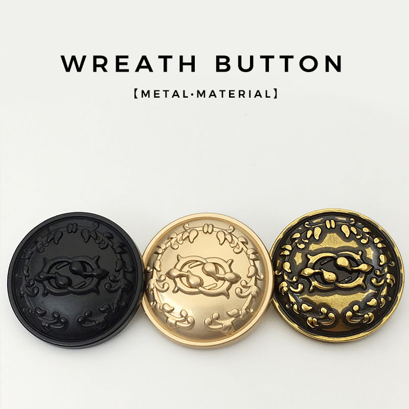 Set of wreath circular metal buttons in black, gold, and bronze finishes