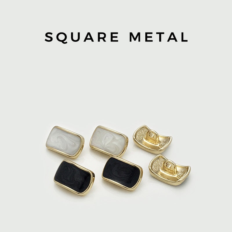 Set of rectangular shirt buttons: white and black oil-spotted fronts, gold metal backs