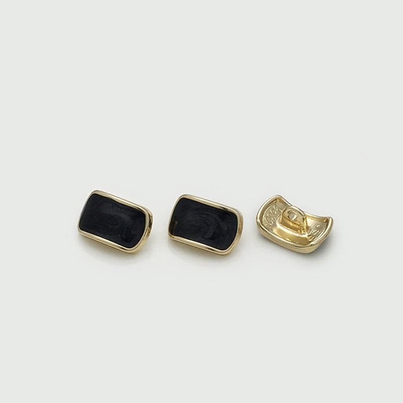 Rectangular shirt buttons: black oil-spotted fronts with gold metal backs