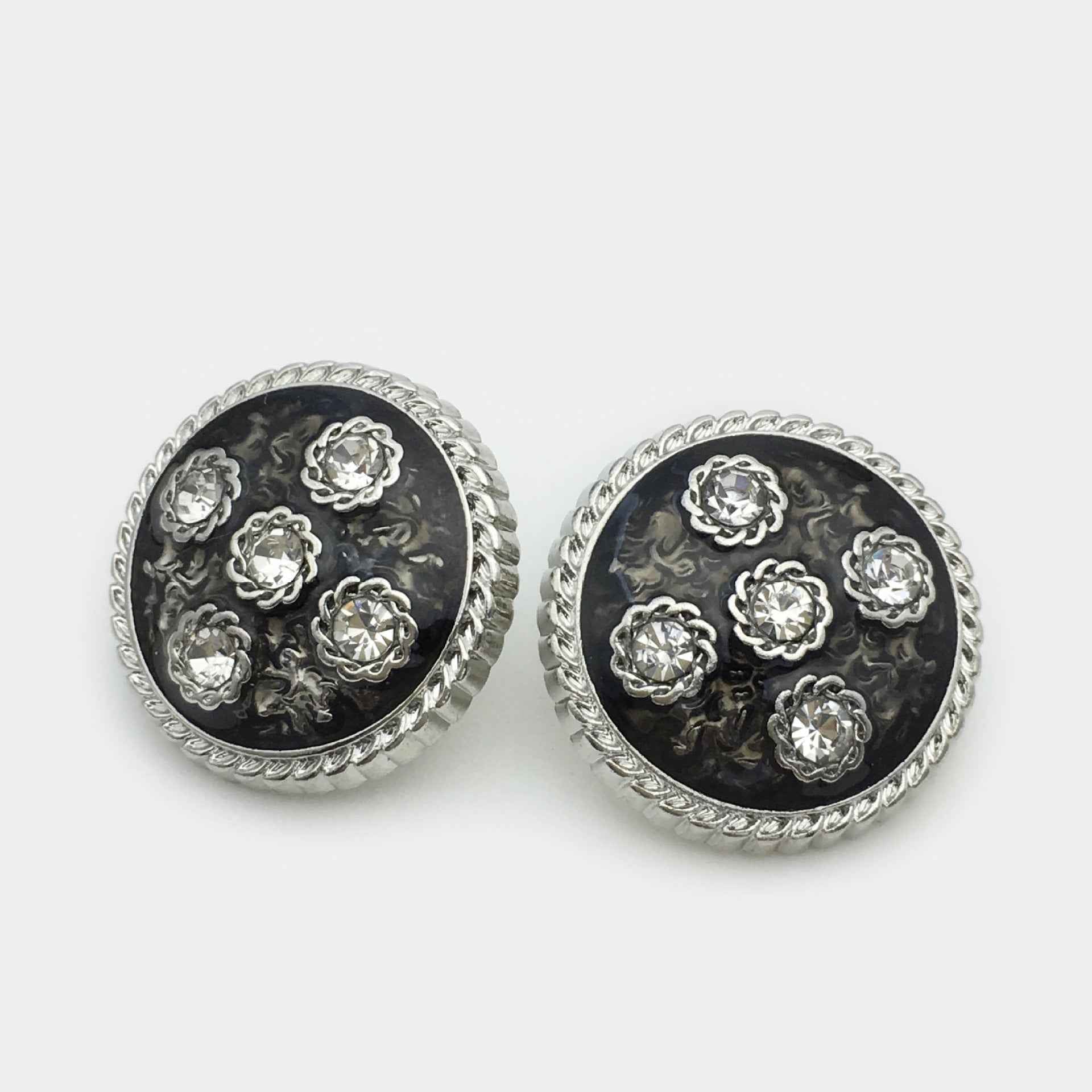 Silver metal coat button pair, round black base with ornate floral diamond rhinestones