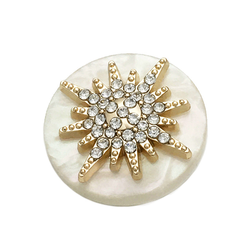 Gold-tone round star button with clear rhinestones, white resin back