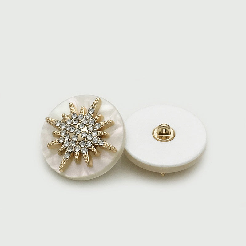 Gold-tone round star button with clear rhinestones; front and metal shank back