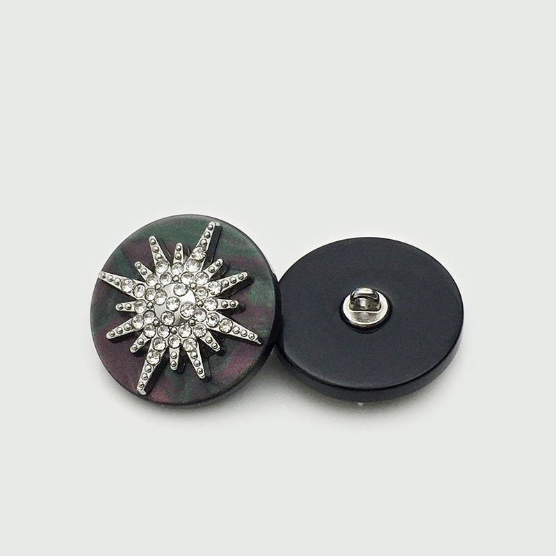 Silver-tone round star button with clear rhinestones on dark resin, metal shank