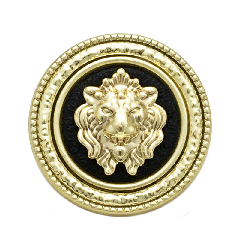 Gold lion-head round metal button with black center, ornate rim