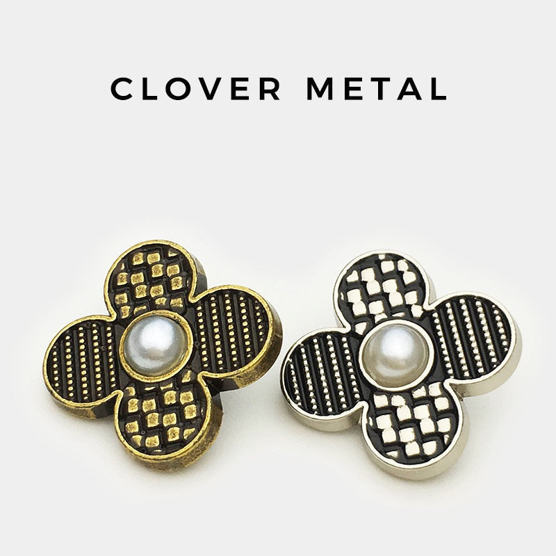 Two four-leaf clover metal buttons: gold-tone and silver-tone, faux pearl centers