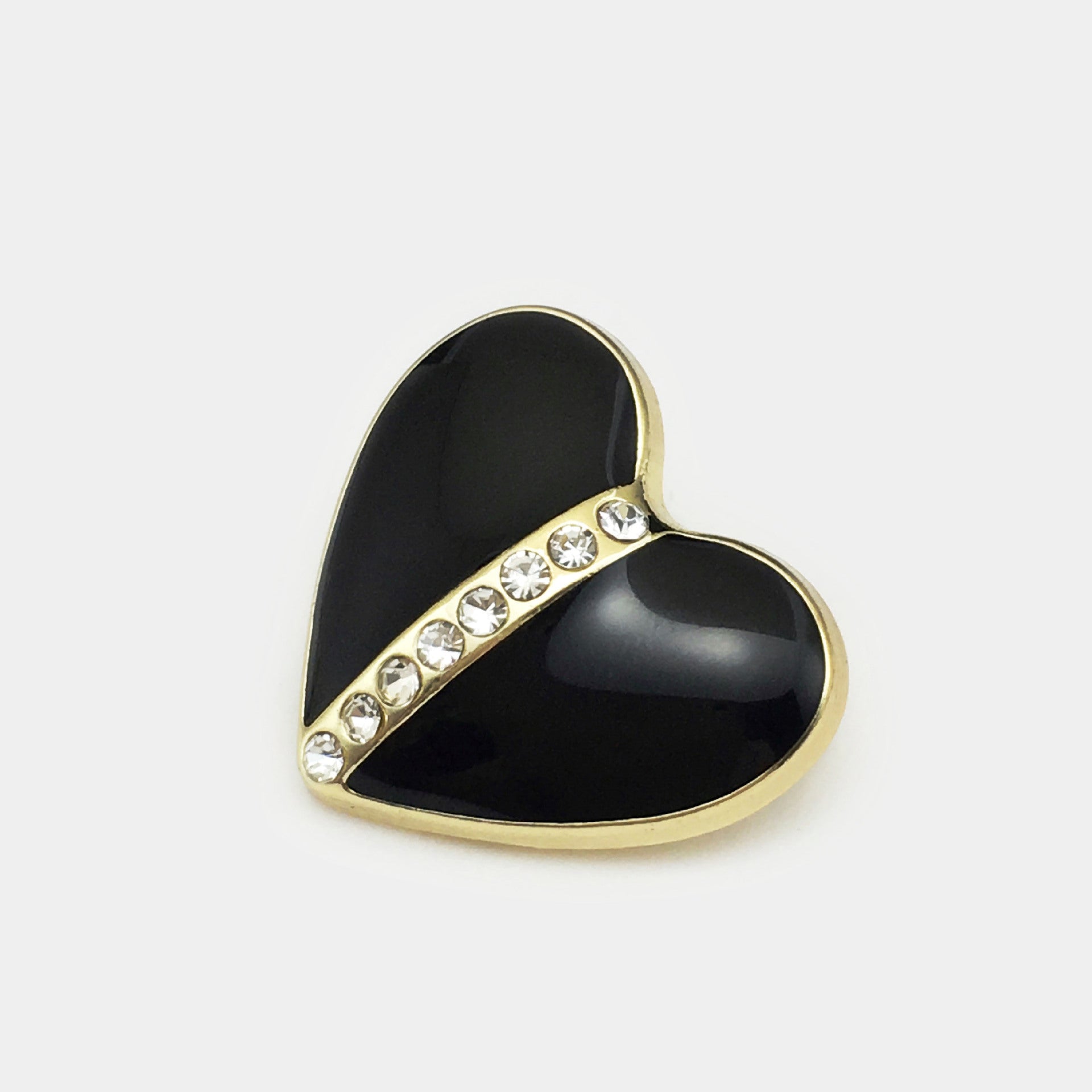 Heart-shaped crystal button in dark enamel with gold-tone rim and clear rhinestones