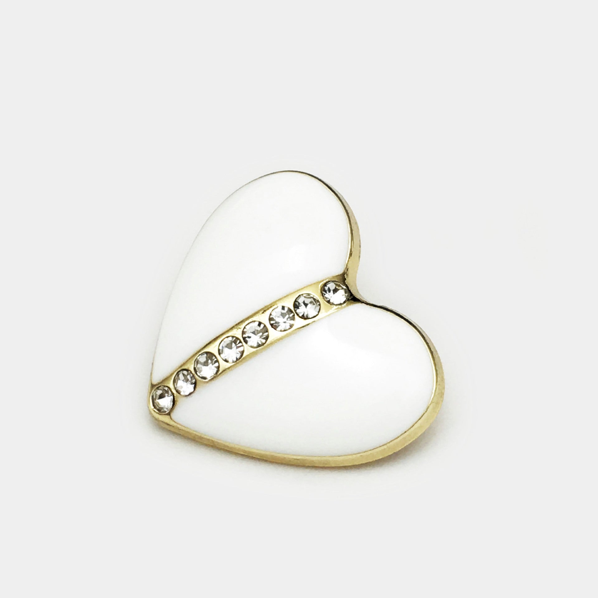 Heart-shaped crystal button with white enamel and gold-tone rim, rhinestone band