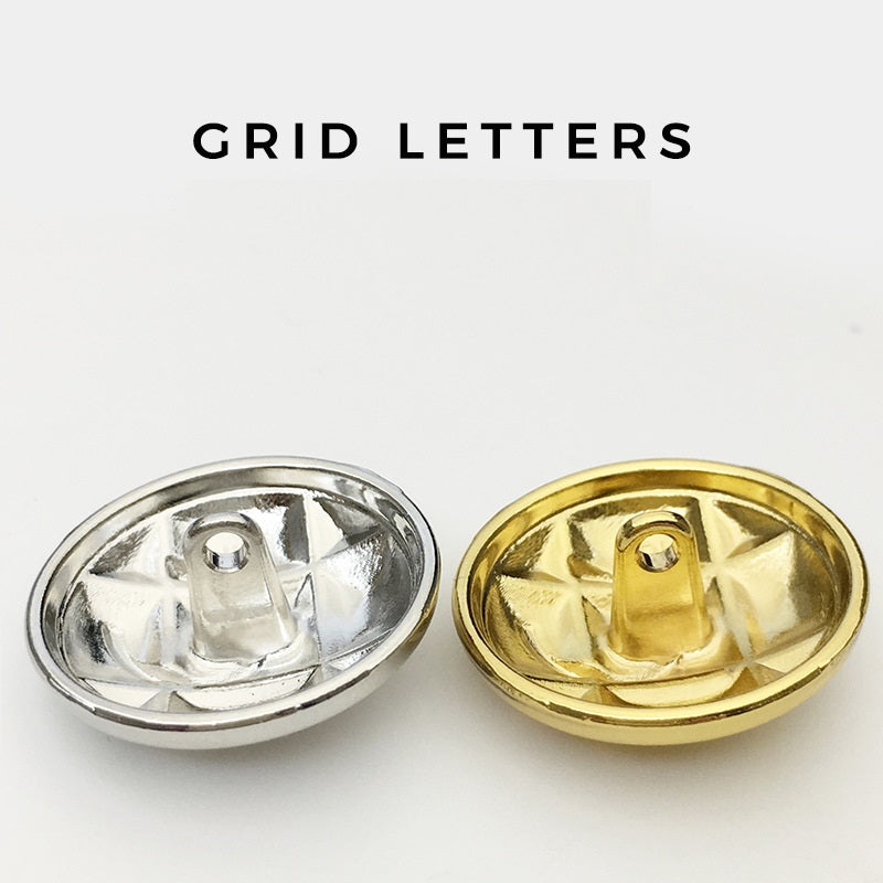 Underside view of letter C metal buttons with shank: silver and gold