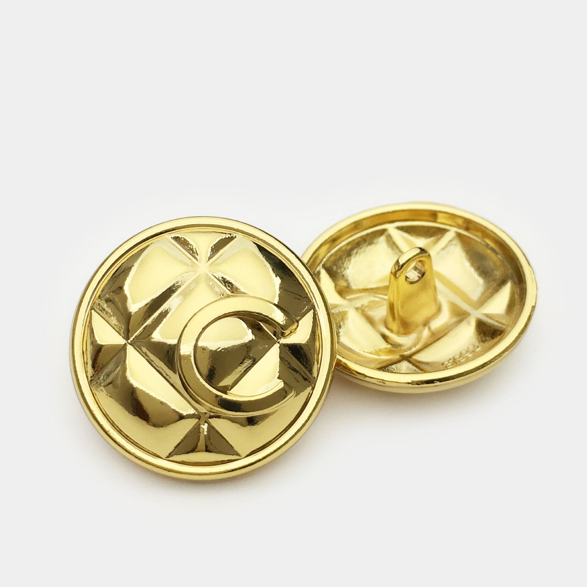 Gold letter C metal button front and back with shank, embossed grid pattern