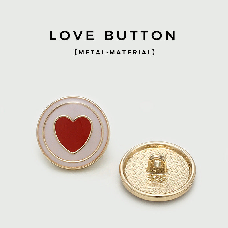 Red heart metal button with gold rim; reverse side shows metal loop shank