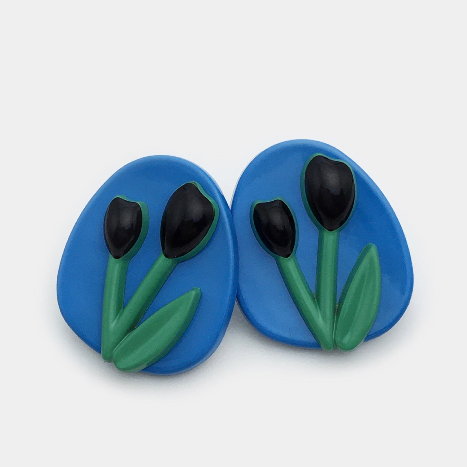 Oval tulip metal buttons, blue face with black tulip petals and green stems