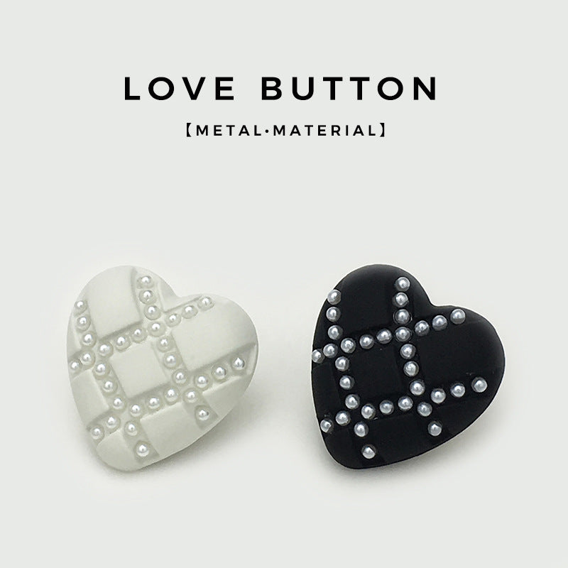 Set of heart buttons: white and black with pearl-look studs in X pattern