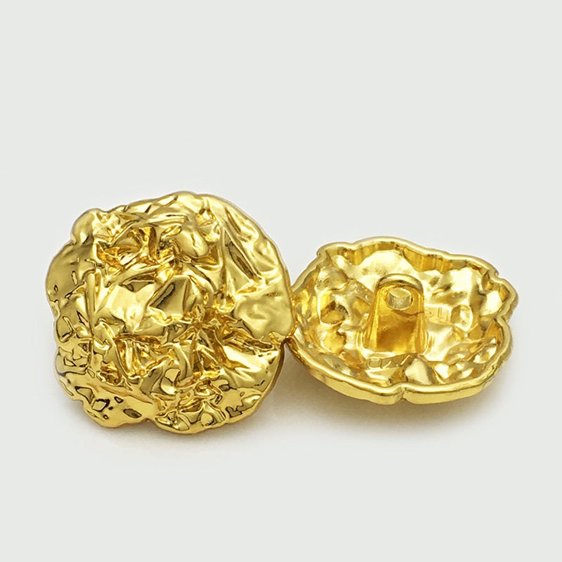 Pair of oversized gold metal buttons, textured irregular oval, one back with loop