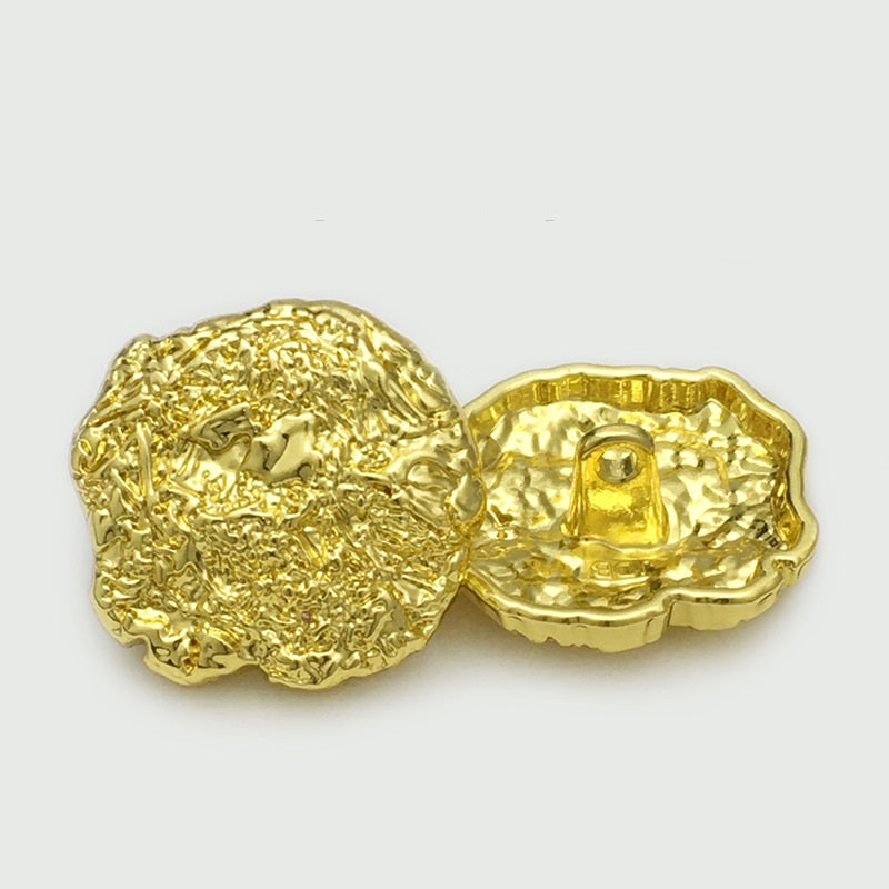 Oversized gold metal button pair, irregular scalloped edges, loop-back shown