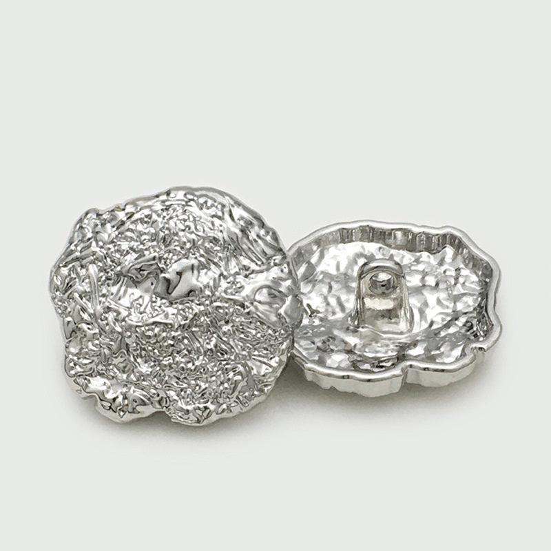 Oversized silver metal button pair, irregular scalloped edges, loop-back shown