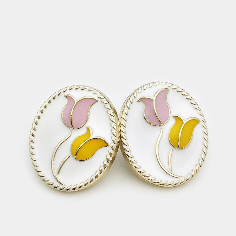 Oval tulip metal jacket buttons on white, pink and yellow tulip details