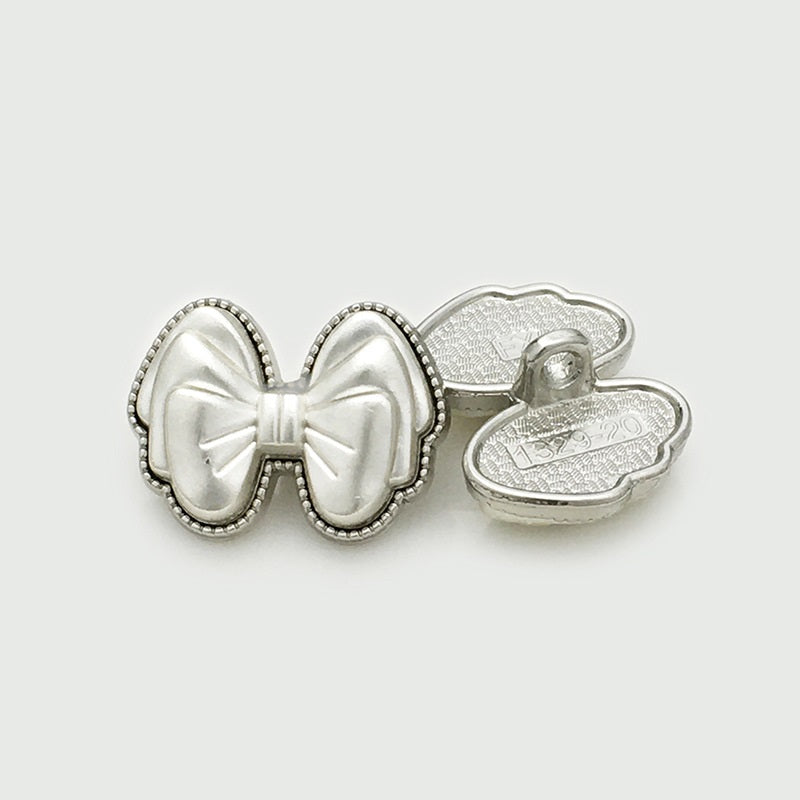 White 3D bow resin button, back view, silver shank marked 1329-20