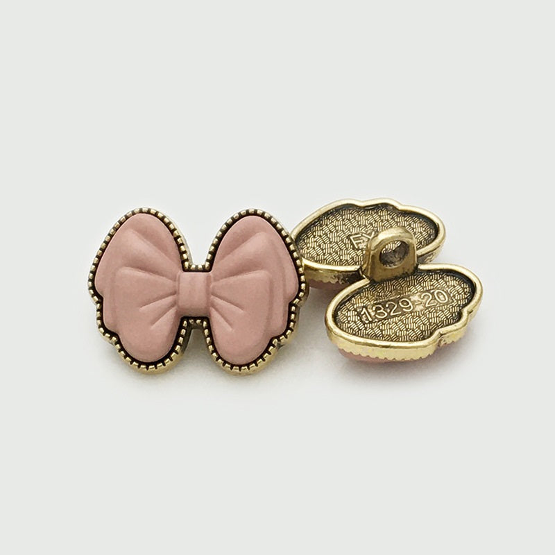 Pink 3D bow resin button, back view, gold shank marked 1329-20