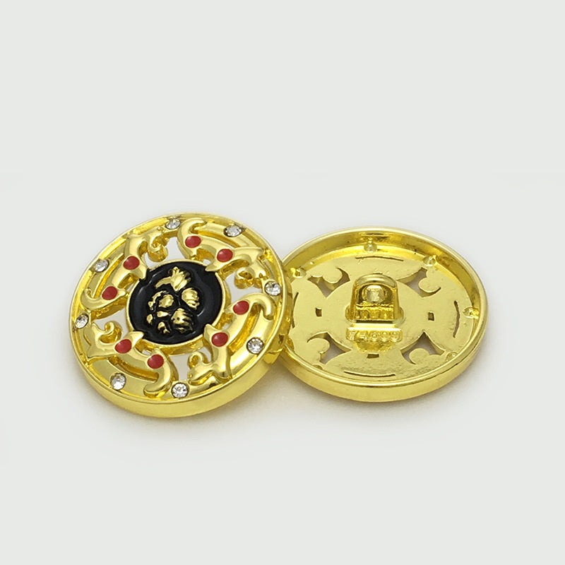 Gold hollow metal button front with black center, red enamel dots, clear rhinestones