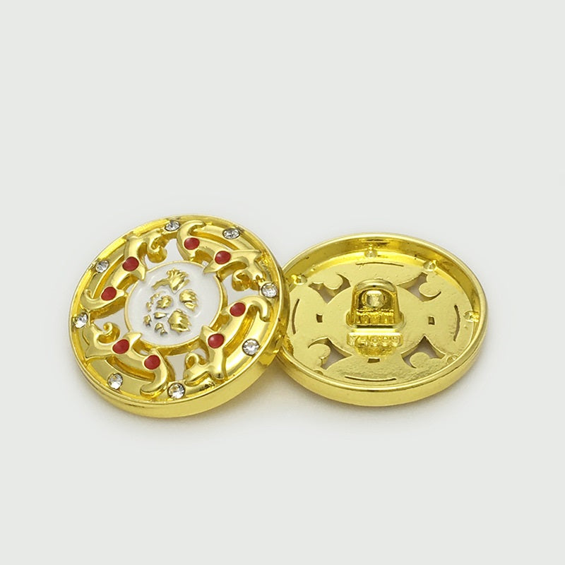 Gold hollow metal button front with white center, ornate filigree, red enamel and gems