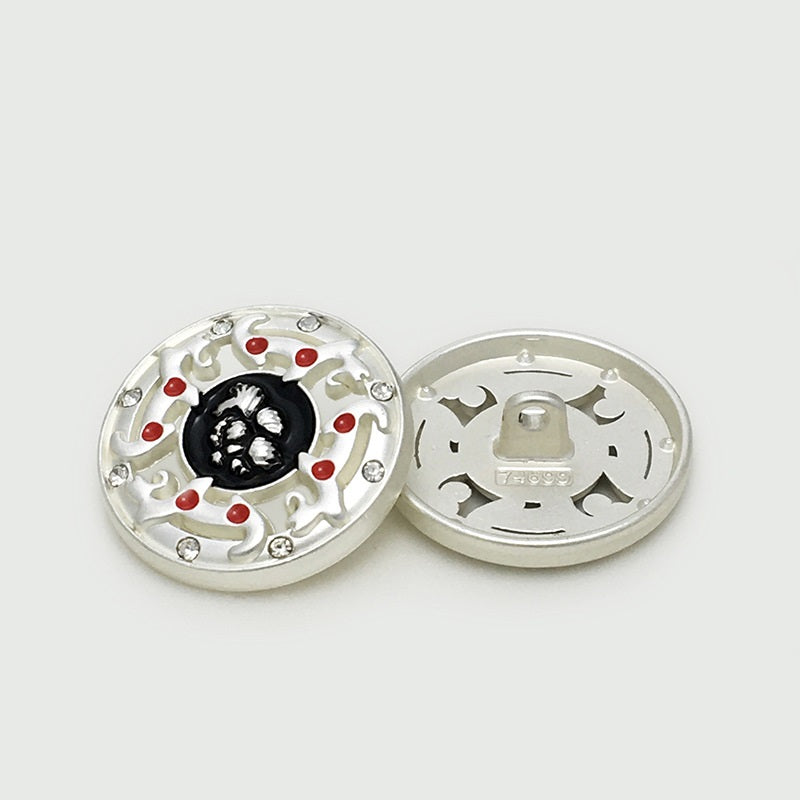 Silver hollow metal button front with black center, red enamel dots, rhinestone edge