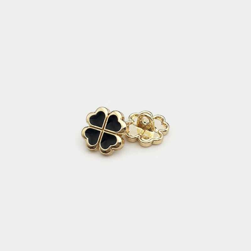 Black four-leaf clover metal button with shank underside, gold-tone