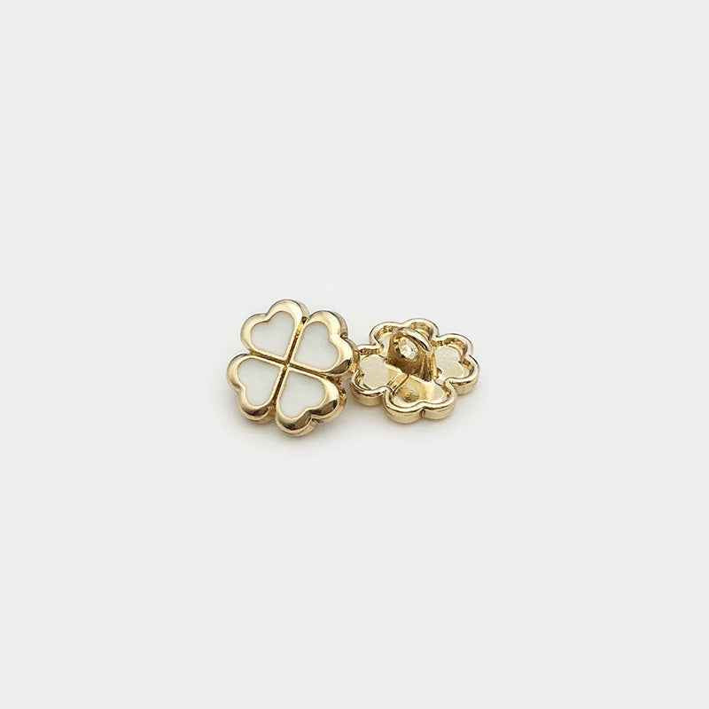White four-leaf clover metal button with shank underside, gold-tone