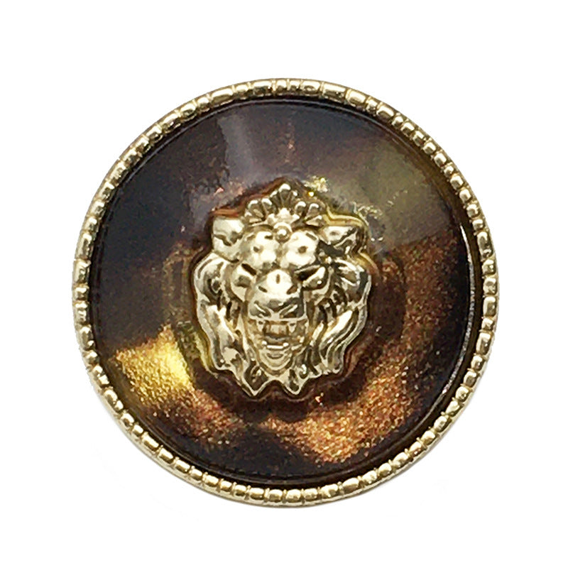 Lion head transparent resin metal button, gold-tone rim and lion face (close-up)