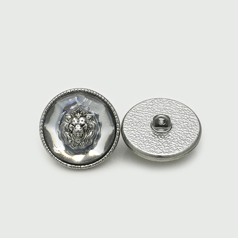 Silver lion head resin metal button, front and back view with gold-tone border