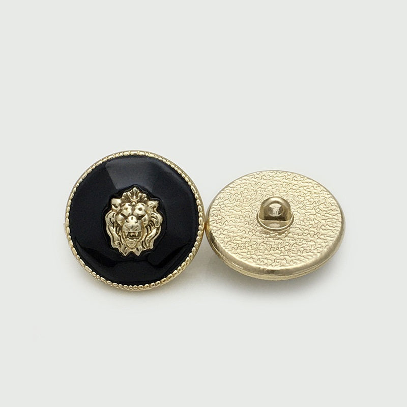 Lion head resin metal button, dark/black front with gold rim; back shows attached shank