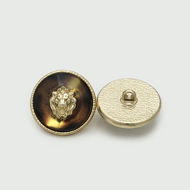 Lion head resin metal button, coffee-gold front with gold rim; back shows shank