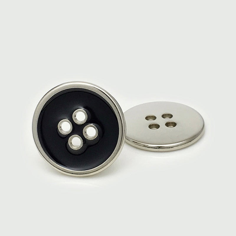 Round four-hole metal button, black face with silver rim and silver back
