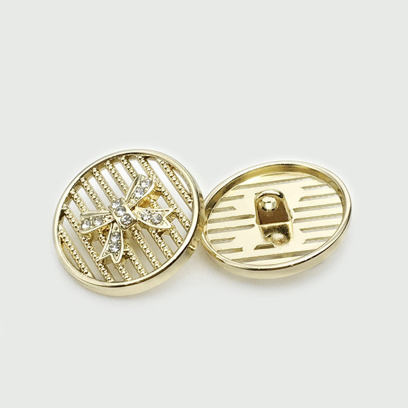 Gold 25mm bowtie metal button, gem starburst front with rhinestones and ridged back.