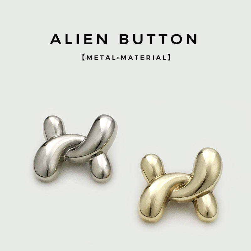 Irregular X-shaped metal buttons in silver and gold tones, polished finish