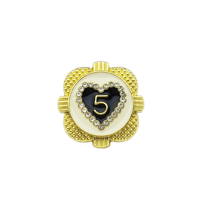 Gold heart-shaped metal button with rhinestone border and '5' center