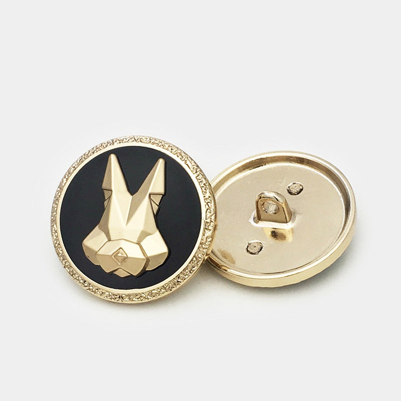 Gold-tone round button back with shank prongs; visible rabbit-head front design
