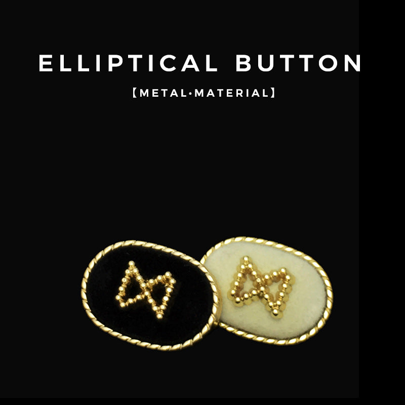 Pair of oval velvet metal buttons: black and white fronts with gold bead motifs