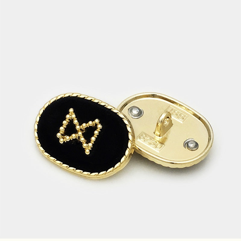 Oval velvet metal button, black front with gold bead motif and metal shank back