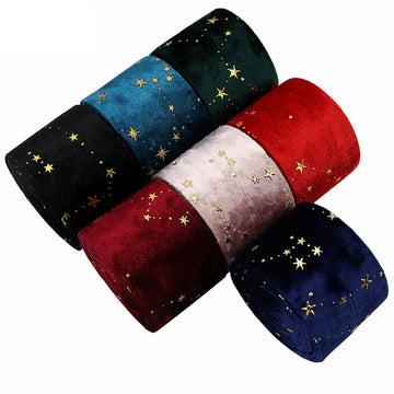 Embroidered velvet ribbon in black with gold star accents, rolled pack