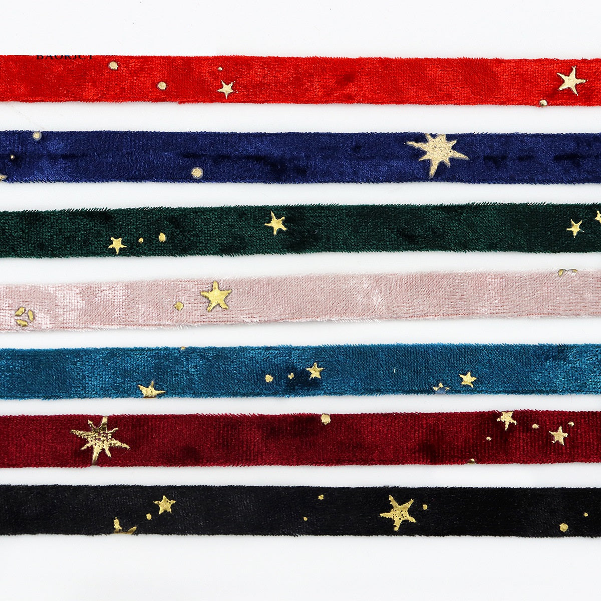 Close-up embroidered velvet ribbon stripes in red, navy, green, blush, black with gold stars