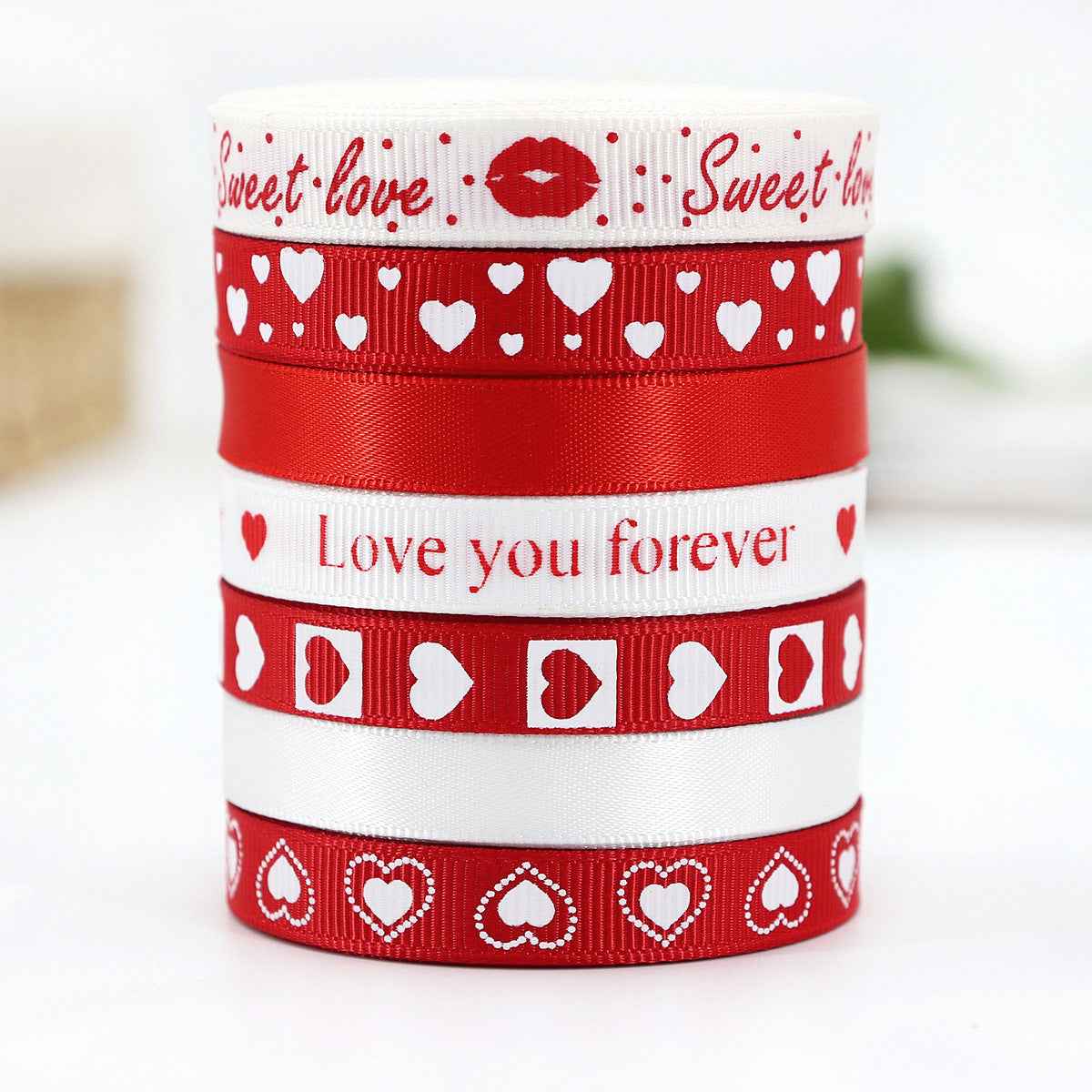 Stacked Valentine ribbons (9mm) with hearts and phrases like “Love you forever”