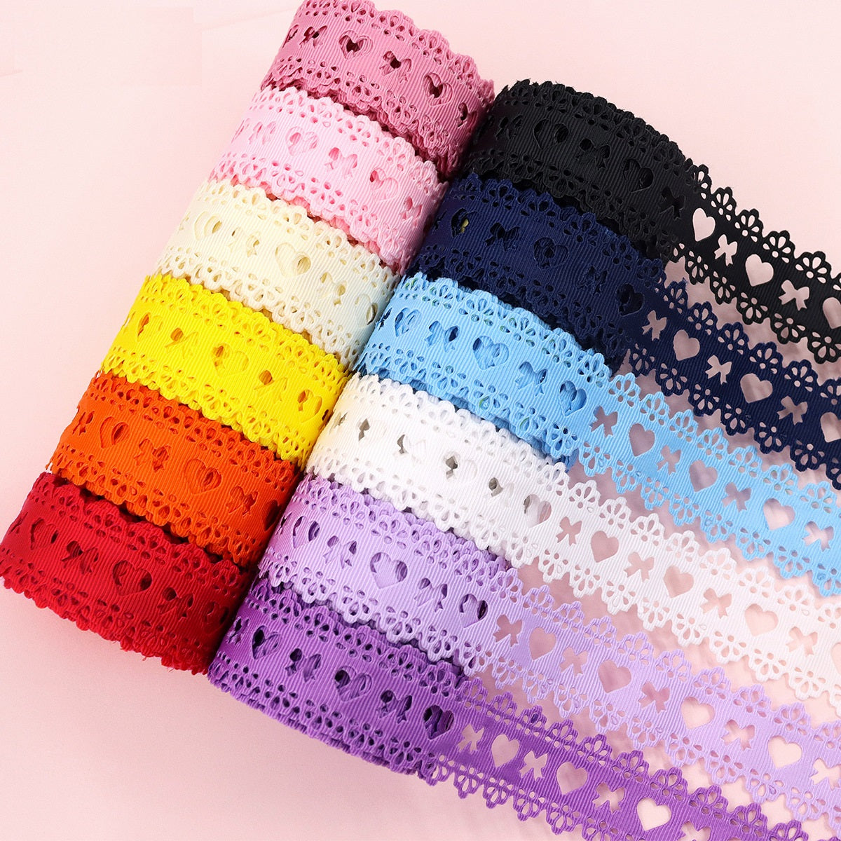 Heart-cutout ribbon rolls in pink, black, blue, purple, white, and red