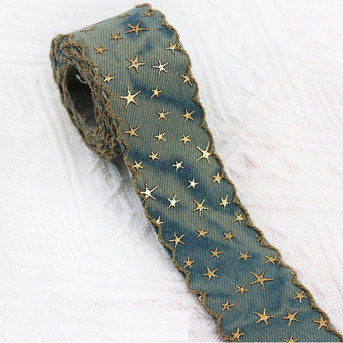 Vintage denim star embroidered ribbon roll in muted blue-green with gold stars