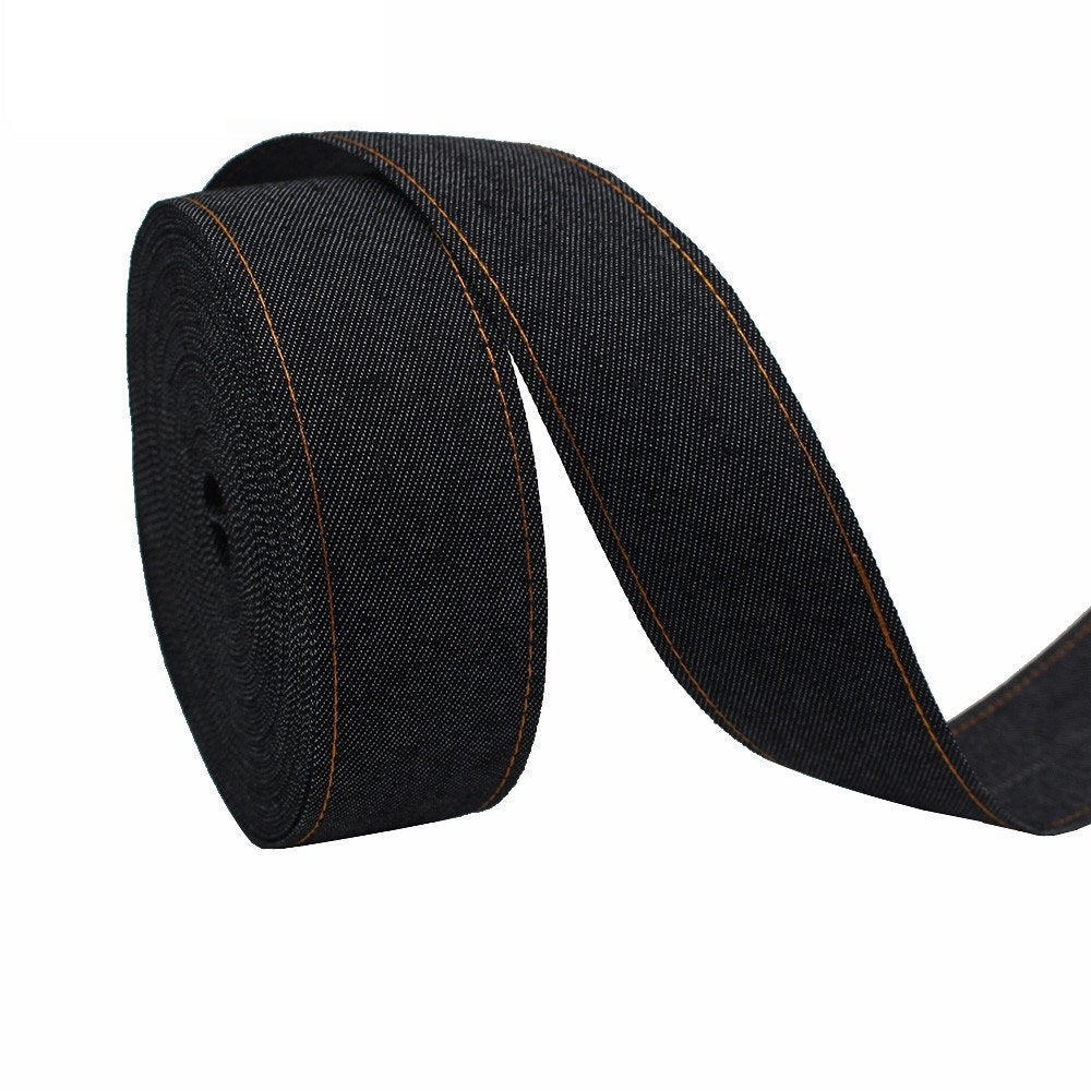 Black denim fabric ribbon with orange edge stitching, rolled fabric strip