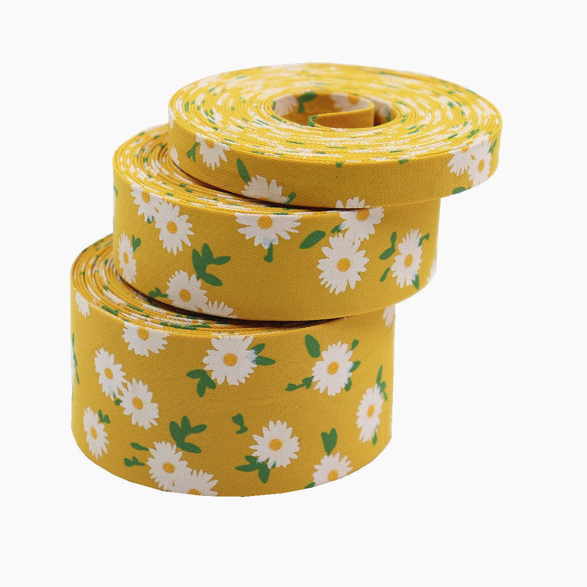 Gelbes Blumen-Stoffband mit weißen Gänseblümchen, aufgerollt mit sichtbarer Innenkante