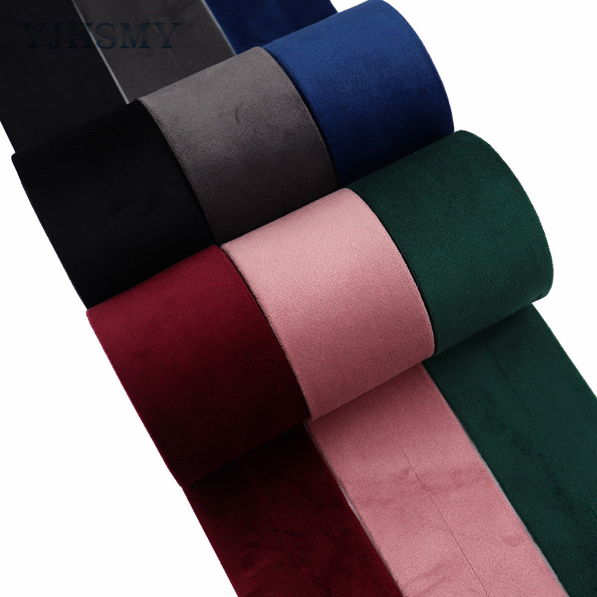 Velvet bias tape ribbon close-up with dark blue, dark grey, black, green, dusty pink, and wine rolls